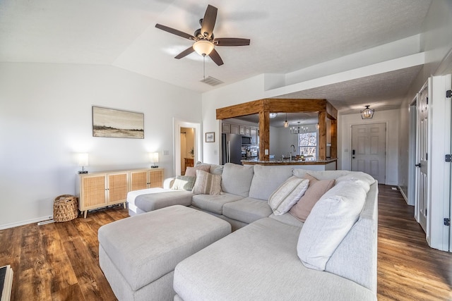 living room with sink, wood-type flooring, ceiling fan, and vaulted ceiling