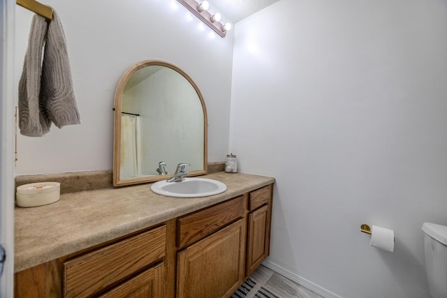 bathroom featuring vanity and toilet