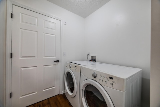 washroom featuring dark hardwood / wood-style floors, independent washer and dryer, and a textured ceiling