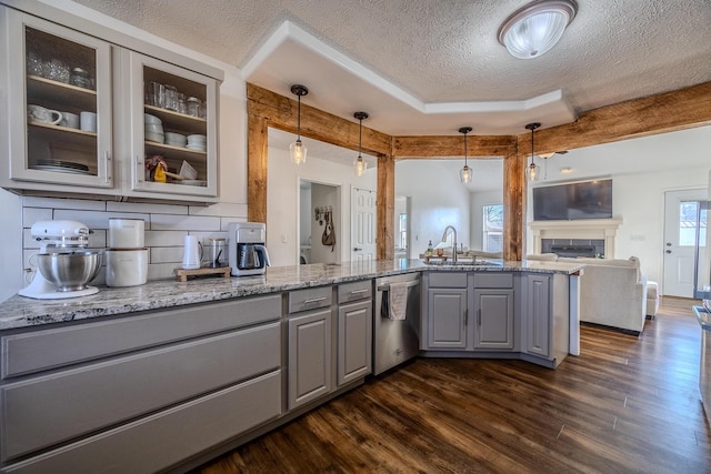 kitchen featuring dishwasher, pendant lighting, gray cabinetry, and light stone counters