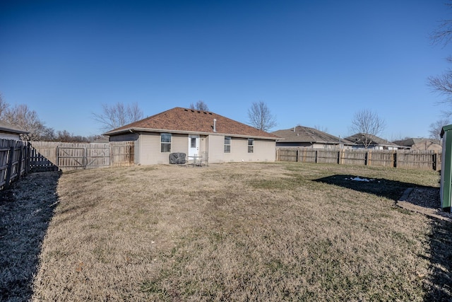 rear view of house featuring a lawn