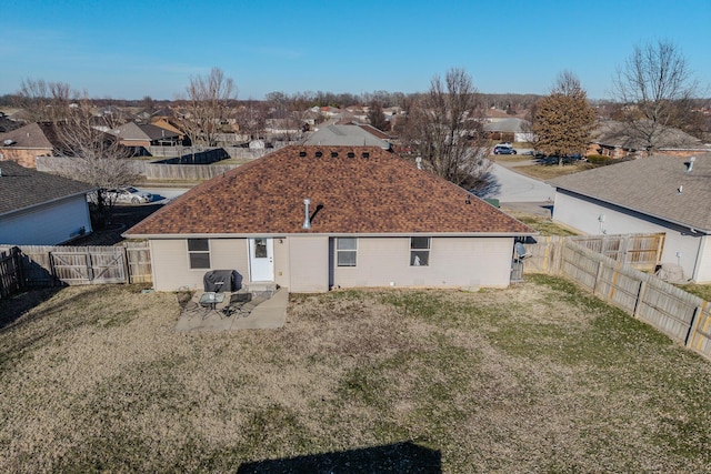 rear view of property featuring a yard and a patio area