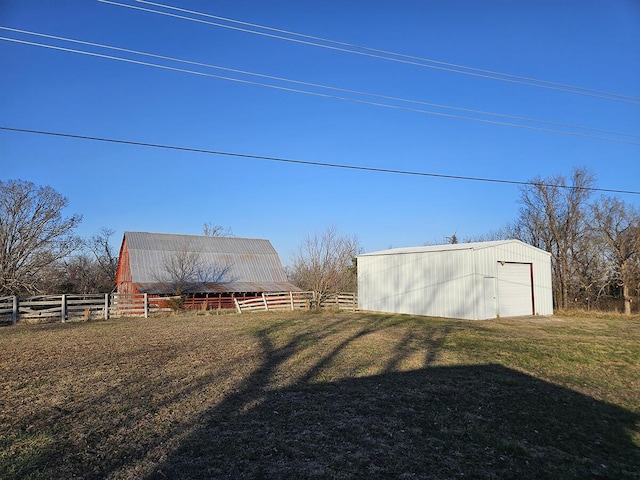 view of yard featuring a rural view and an outdoor structure