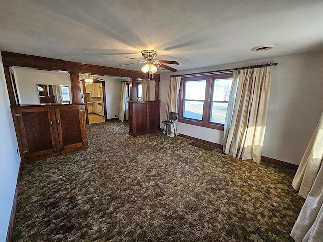 interior space featuring ceiling fan and dark colored carpet