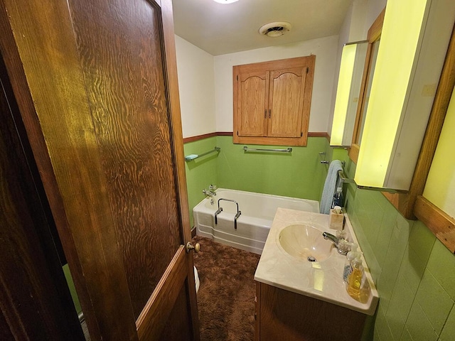 bathroom with vanity and a tub