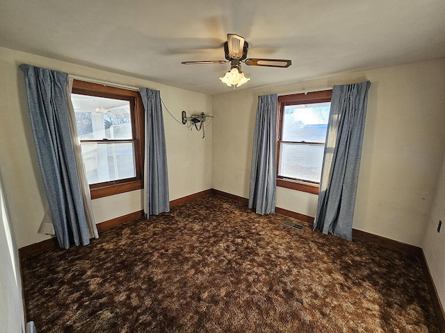 carpeted spare room featuring ceiling fan