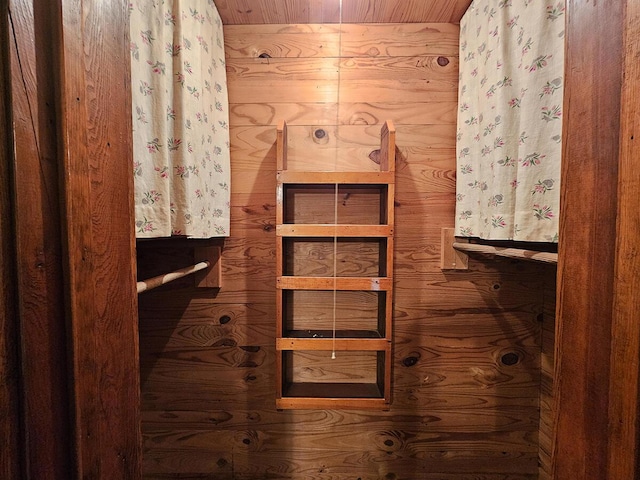 bathroom with wooden walls and wooden ceiling