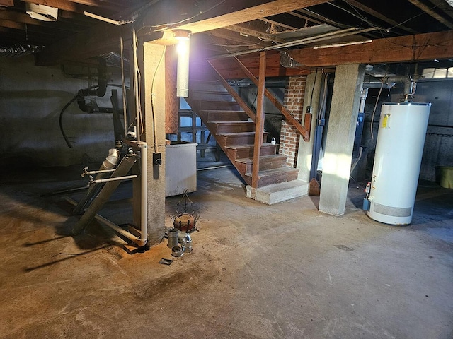 basement featuring water heater and washer / dryer