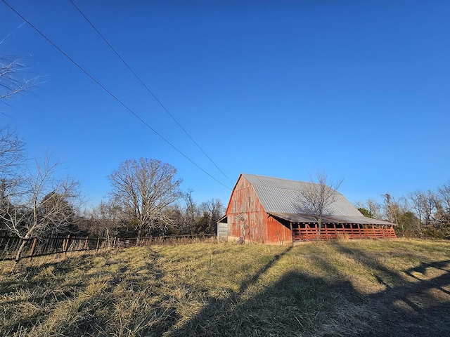 view of yard with an outdoor structure and a rural view