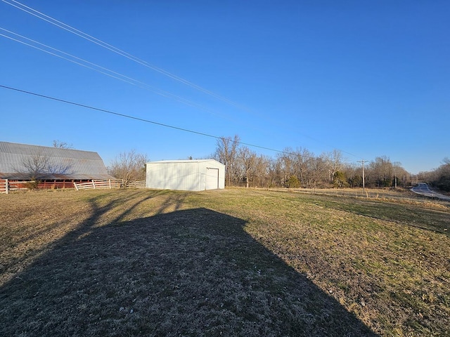 view of yard with an outbuilding and a rural view