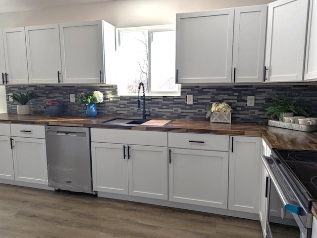 kitchen featuring white cabinets, appliances with stainless steel finishes, sink, and wooden counters