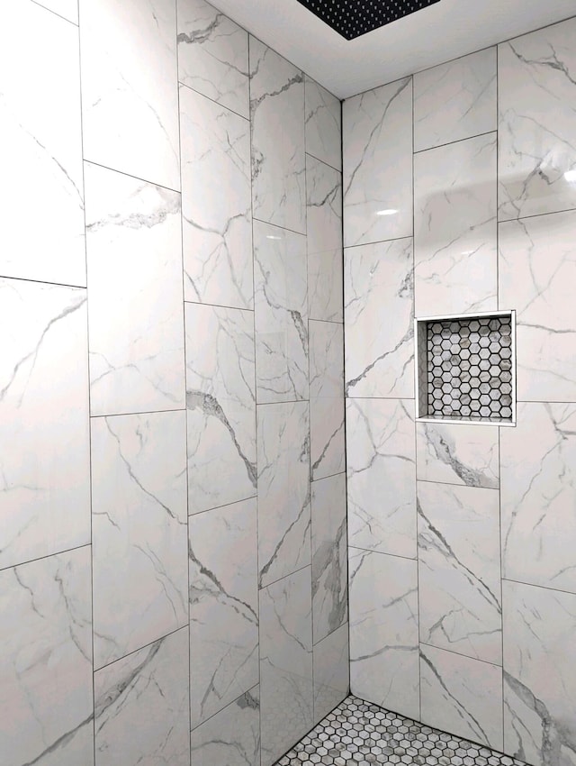 bathroom with a tile shower