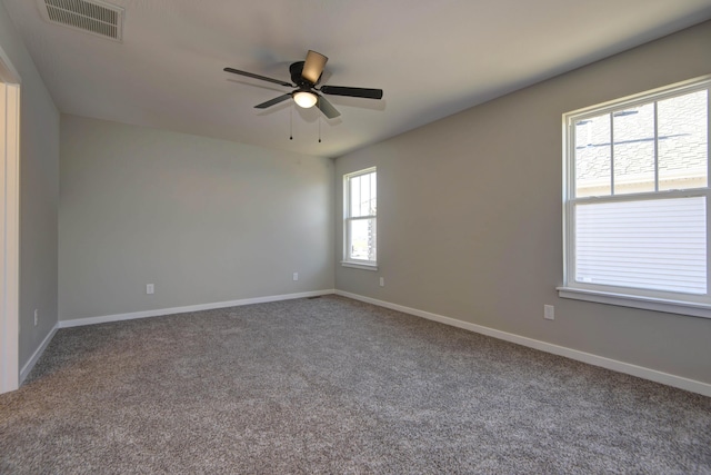 carpeted spare room with ceiling fan