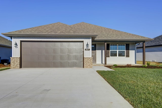 view of front of home with a garage and a front lawn