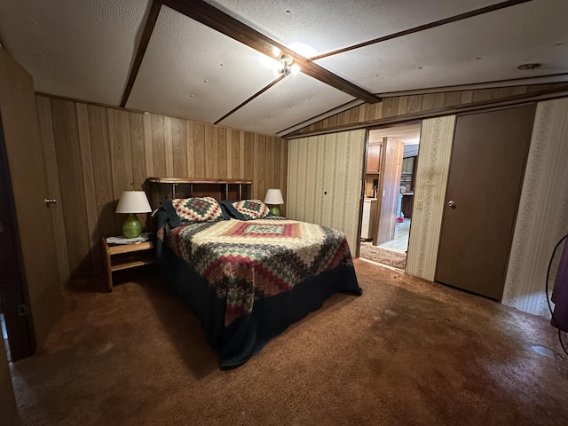 bedroom featuring dark carpet and lofted ceiling with beams