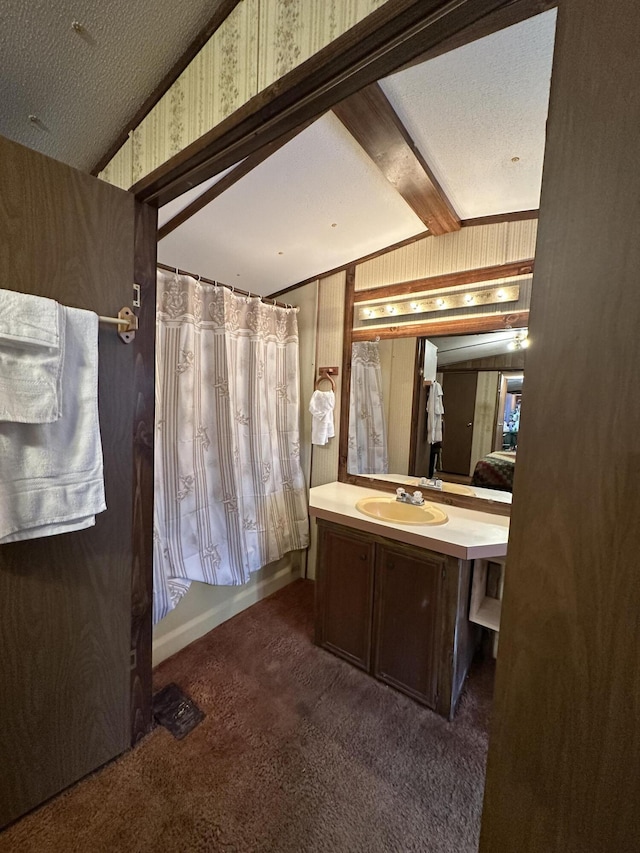 bathroom with shower / bath combo, a textured ceiling, vanity, and wooden walls