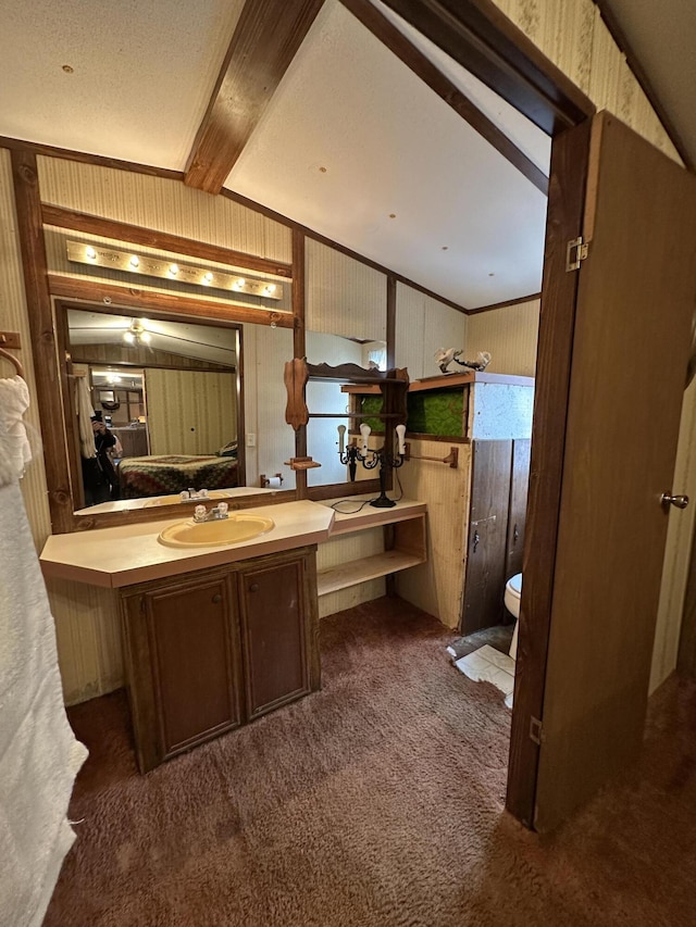 bathroom featuring vanity, beam ceiling, and wooden walls