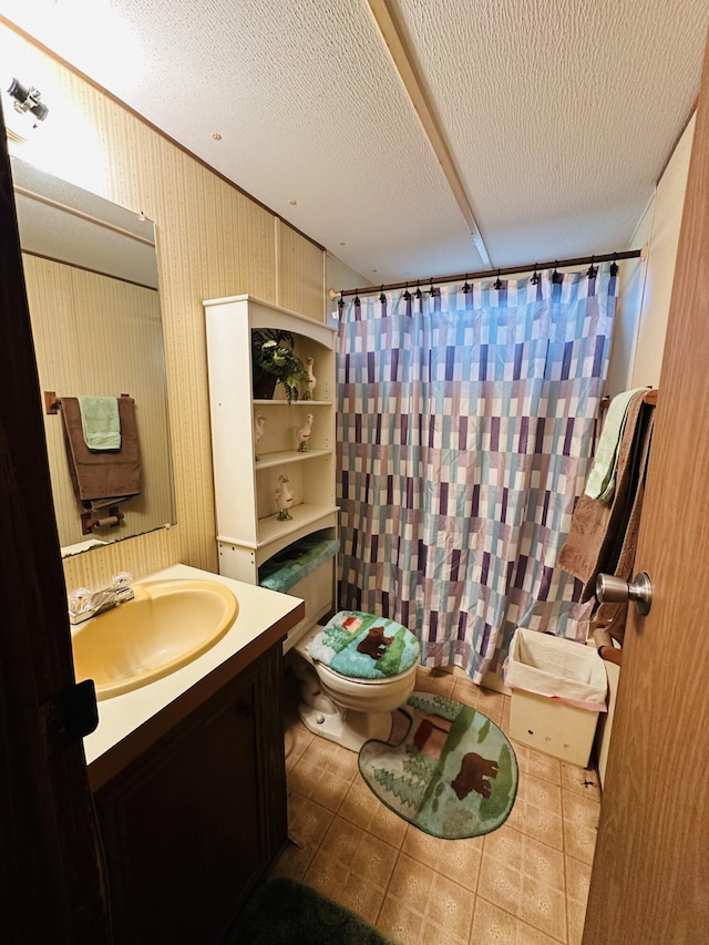 bathroom with vanity, walk in shower, a textured ceiling, and toilet