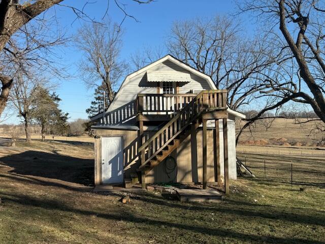 view of outdoor structure with a rural view and a yard