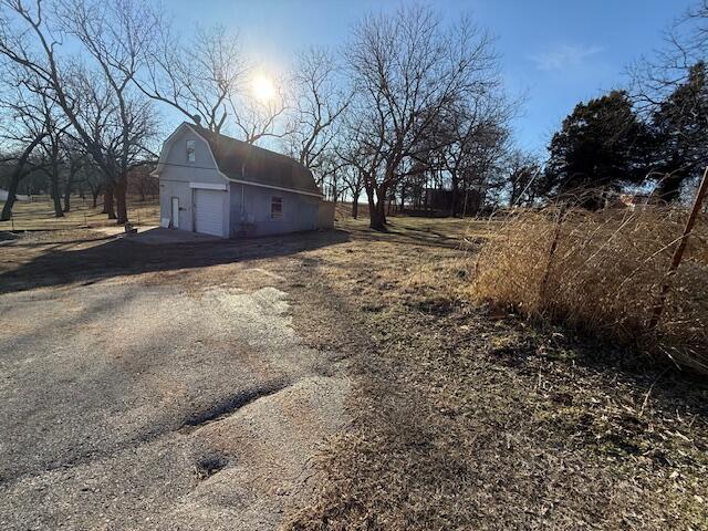 view of side of property featuring a garage and an outdoor structure