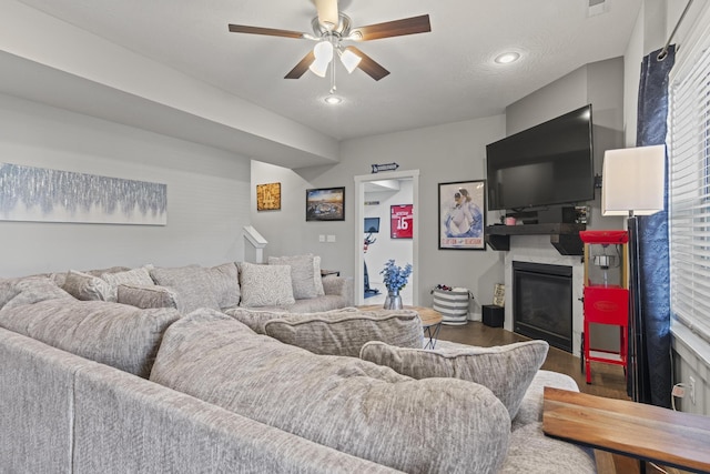 living room with dark wood-type flooring and ceiling fan