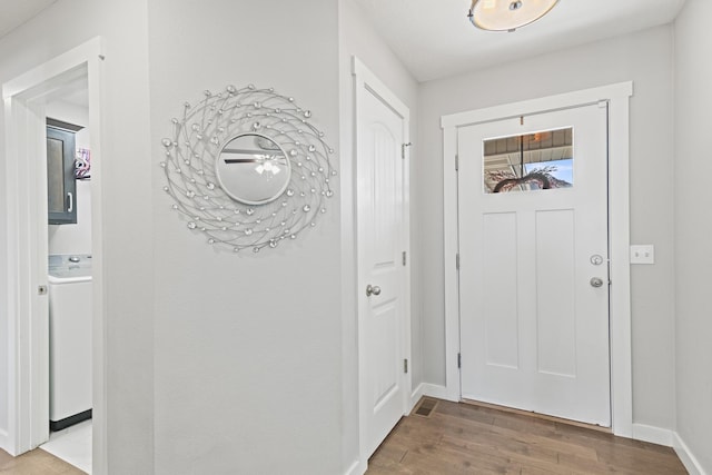 entryway with washer / clothes dryer and wood-type flooring