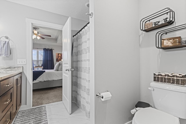 bathroom featuring vanity, ceiling fan, and toilet