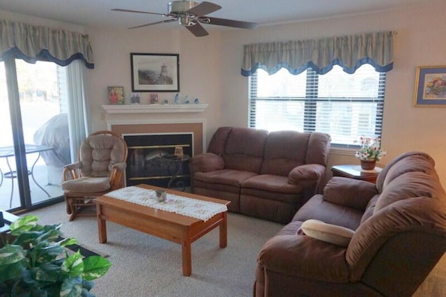 carpeted living room featuring ceiling fan