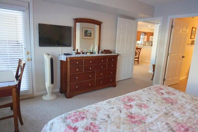 bedroom featuring light colored carpet