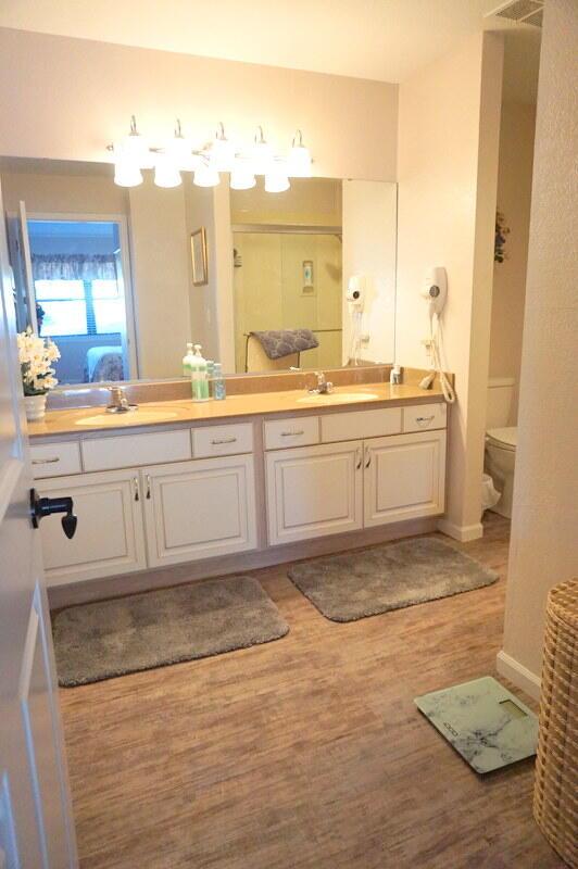 bathroom with vanity, hardwood / wood-style floors, and toilet