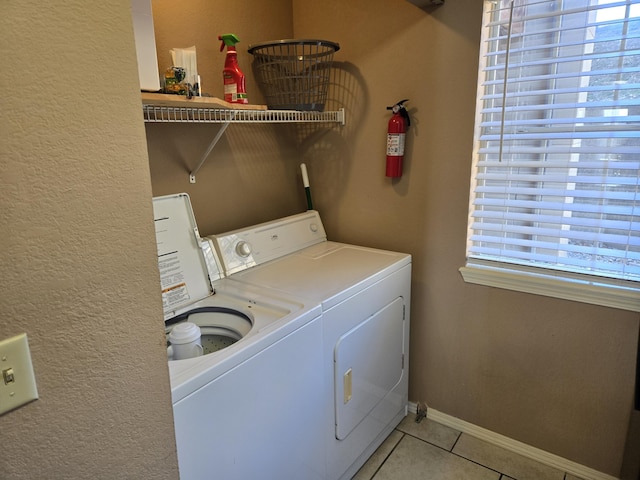 washroom featuring washing machine and dryer and light tile patterned flooring