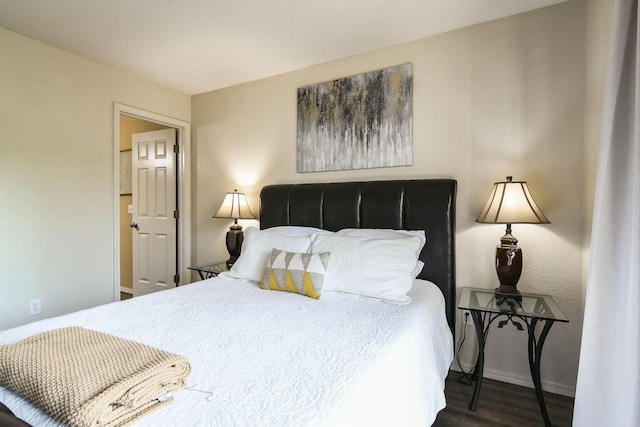 bedroom with dark wood-type flooring