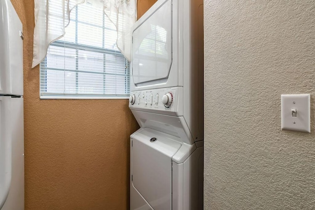 laundry room with stacked washing maching and dryer