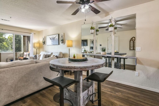 dining area featuring dark hardwood / wood-style flooring and ceiling fan