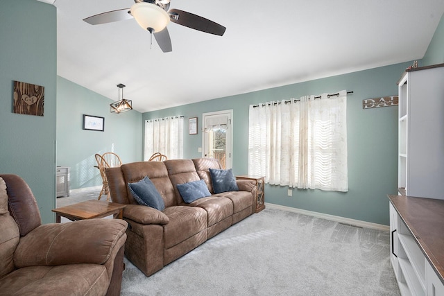 living room with lofted ceiling, light colored carpet, and ceiling fan