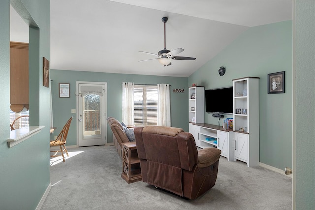 living room with vaulted ceiling, light colored carpet, and ceiling fan