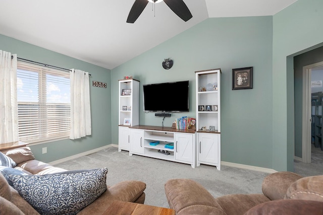 carpeted living room featuring ceiling fan and vaulted ceiling