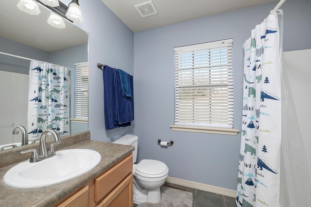 bathroom with tile patterned flooring, vanity, curtained shower, and toilet