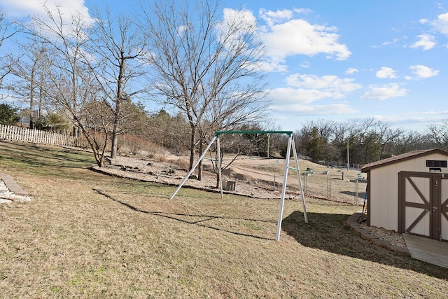 view of yard with a playground and a storage unit