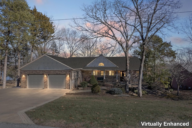 view of front of property with a garage and a yard