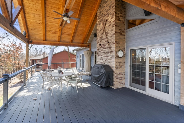 wooden terrace featuring ceiling fan and grilling area