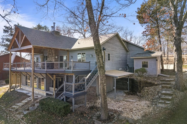 back of property featuring a wooden deck