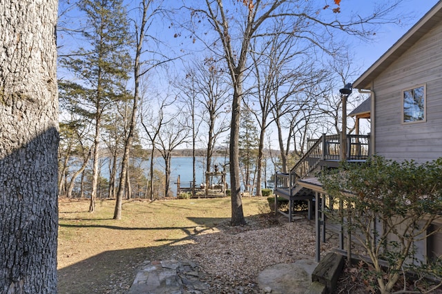 view of yard featuring a deck with water view