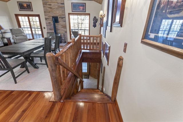 stairs featuring french doors and wood-type flooring