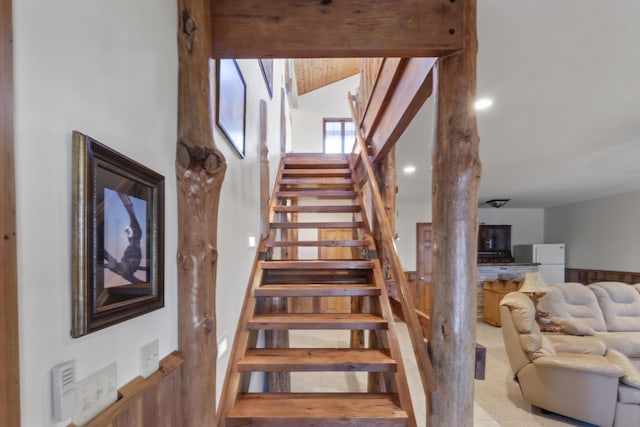 staircase featuring lofted ceiling