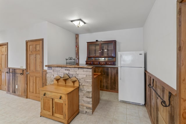 kitchen featuring white refrigerator and kitchen peninsula