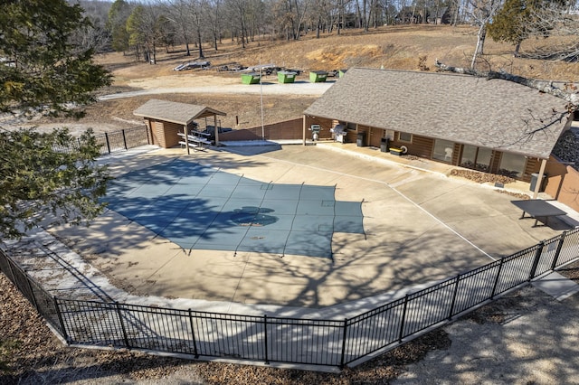 view of pool featuring a storage unit and a patio area