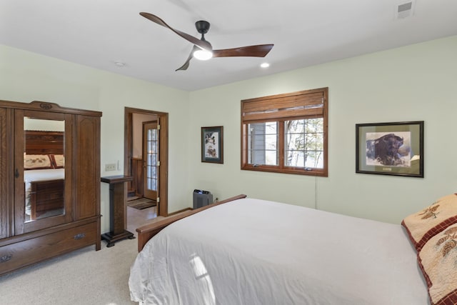 bedroom featuring light colored carpet and ceiling fan