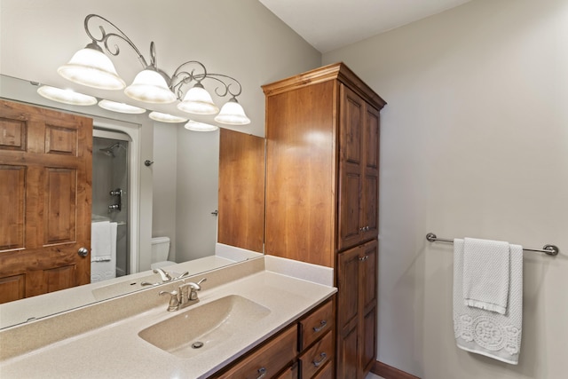 bathroom featuring vanity, toilet, and a shower