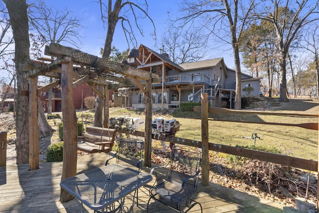 wooden deck featuring a yard